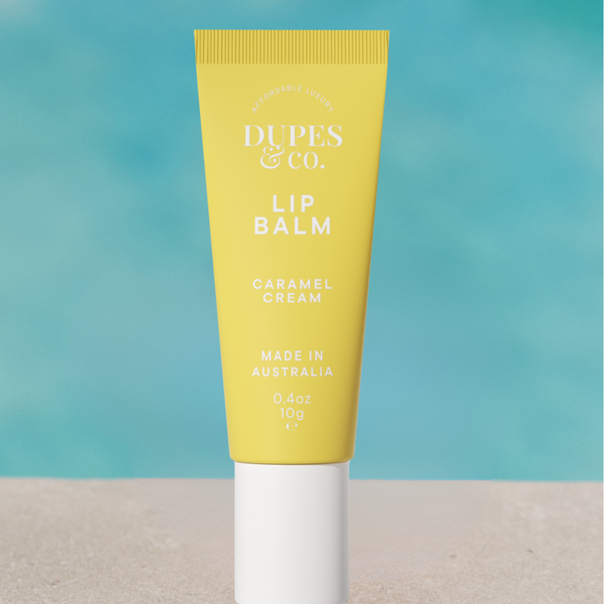 Dupes & Co Caramel Cream Lip Balm tube front view